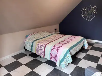 a bedroom with a bed and a checkered floor at Meerdaal in Oud-Heverlee