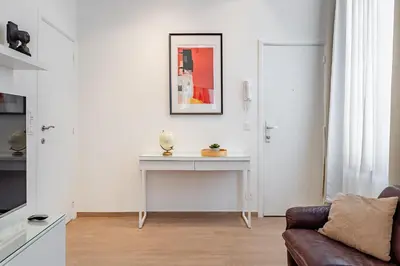 a living room with a couch and a table at Fully furnished and modern flat - Brussels center in Brussels