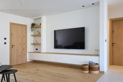a living room with a flat screen tv on a wall at luxurious home in Oud-Turnhout