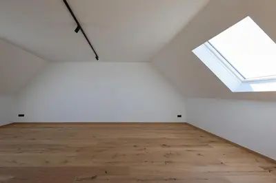 an empty room with a window and a wooden floor at luxurious home in Oud-Turnhout