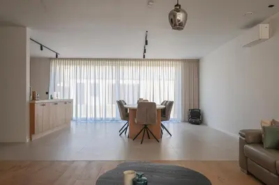 a living room with a table and a couch at luxurious home in Oud-Turnhout