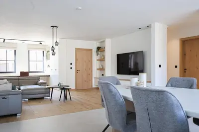 a living room with a table and chairs and a couch at luxurious home in Oud-Turnhout