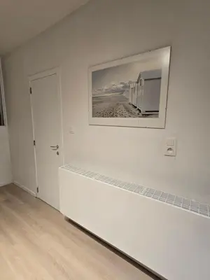 a white room with a picture on the wall at Cityhome in Brussels