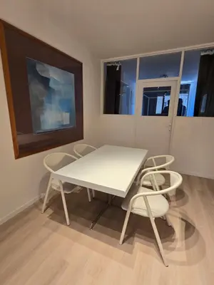 a white table and chairs in a room at Cityhome in Brussels