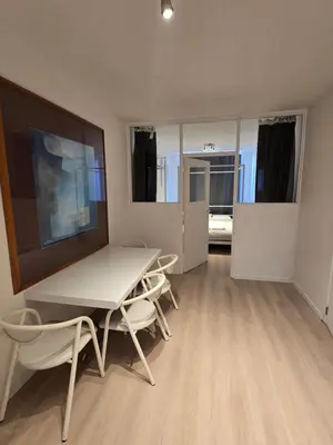 a dining room with a table and chairs in a room at Cityhome in Brussels