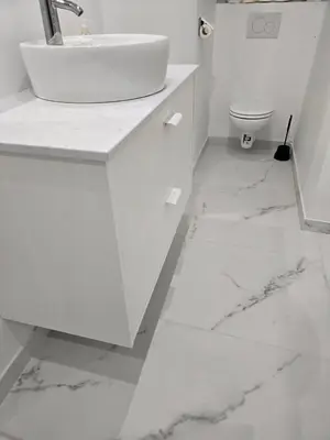 a white bathroom with a sink and a toilet at Cityhome in Brussels