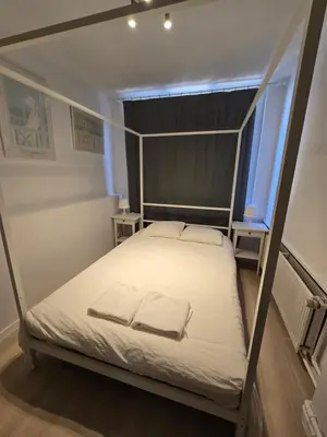 a bed with two pillows on it in a room at Cityhome in Brussels