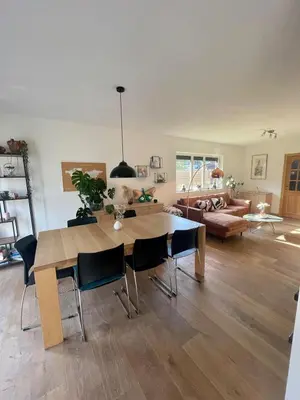 a living room with a table and a couch at Lovely house next to Tomorrowland in Boom