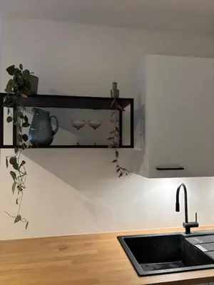 a kitchen with a sink and two glasses on a shelf at Lovely house next to Tomorrowland in Boom