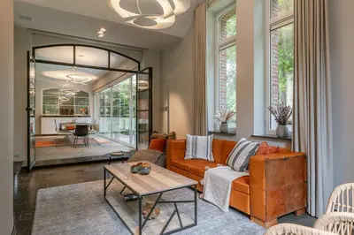 a living room with a couch and a table at Villa Gentbos - currently 15beds 3bathrooms - from june 2026 up to 21beds 6bathrooms in Pataterhoek