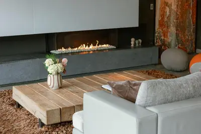 a living room with a couch and a fireplace at Villa Gentbos - currently 15beds 3bathrooms - from june 2026 up to 21beds 6bathrooms in Pataterhoek