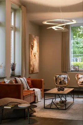 a living room with a couch and a table at Villa Gentbos - currently 15beds 3bathrooms - from june 2026 up to 21beds 6bathrooms in Pataterhoek