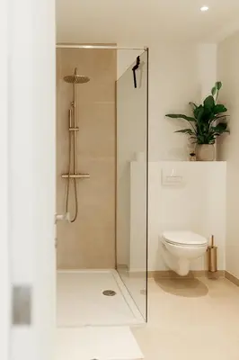 a bathroom with a toilet and a glass shower at Studio&Stay Room in Ghent