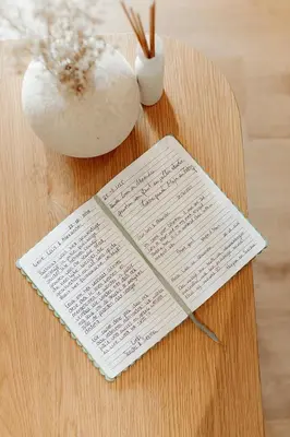 a sheet of music on a table next to a vase at Studio&Stay Room in Ghent