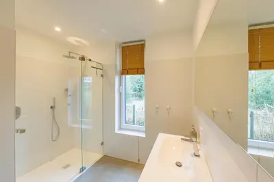 a bathroom with a shower and a tub and a sink at B&B Zoersel in Zoersel