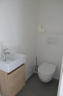 a bathroom with a white sink and a toilet at B&B Zoersel in Zoersel