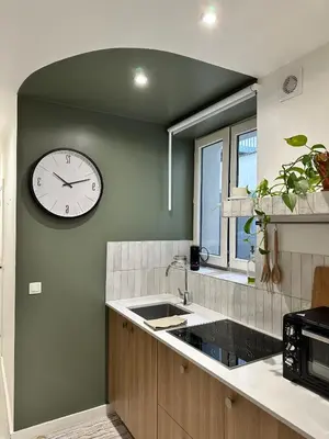a kitchen with a large clock on the wall at New studio centre in Brussels