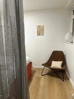 a room with a chair and a curtain at New studio centre in Brussels