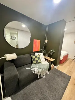 a living room with a couch and a mirror at New studio centre in Brussels