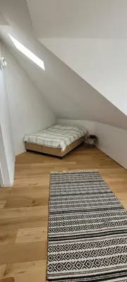 a mattress sitting on a floor in a room with a rug at DokAttic50 in Ghent