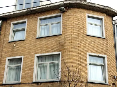 a brick building with six windows on it at DokAttic50 in Ghent