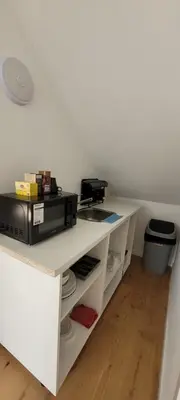 a white desk with a microwave on top of it at DokAttic50 in Ghent