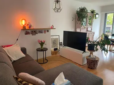 a living room with a couch and a flat screen tv at Perfect for Tomorrowland in Edegem