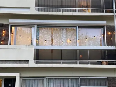 an apartment building with a balcony with christmas lights at Perfect for Tomorrowland in Edegem