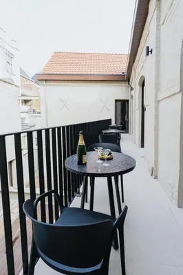 a row of tables and chairs on a balcony at Raibu Antwerp by StayC in Antwerp