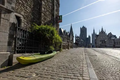 a yellow canoe sitting on the side of a street at Hostel Uppelink in Ghent