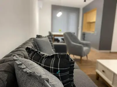 a living room with a gray couch and chairs at Merjay Garden Residence in Brussels