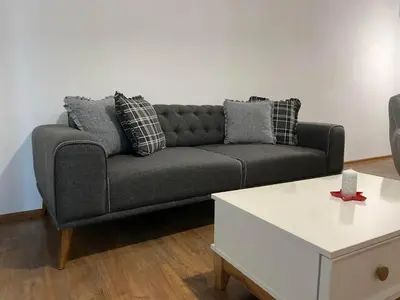 a living room with a couch and a coffee table at Merjay Garden Residence in Brussels