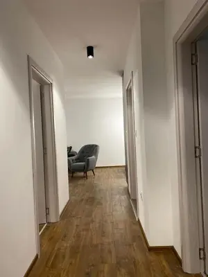an empty hallway with a chair and a couch at Merjay Garden Residence in Brussels