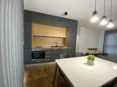 a kitchen with a table and a counter top at Merjay Garden Residence in Brussels