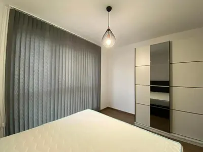 a bedroom with a white bed and a curtain at Merjay Garden Residence in Brussels