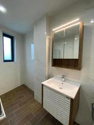 a bathroom with a sink and a mirror at Merjay Garden Residence in Brussels