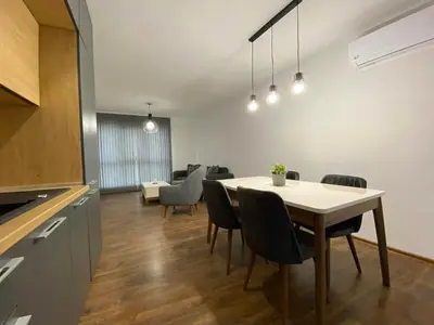 a kitchen and dining room with a table and chairs at Merjay Garden Residence in Brussels