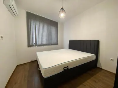a bedroom with a bed in a room with a window at Merjay Garden Residence in Brussels