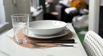 a bowl and a glass sitting on top of a table at Spacious and Chic 1BR - Separate Kitchen & Washer in Brussels