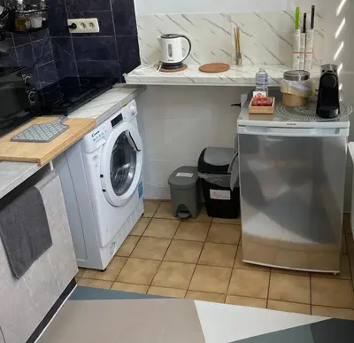 a kitchen with a washer and a washing machine at Spacious and Chic 1BR - Separate Kitchen & Washer in Brussels