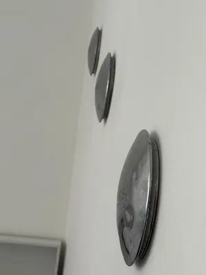 a metal object is hanging on a wall at Spacious and Chic 1BR - Separate Kitchen & Washer in Brussels