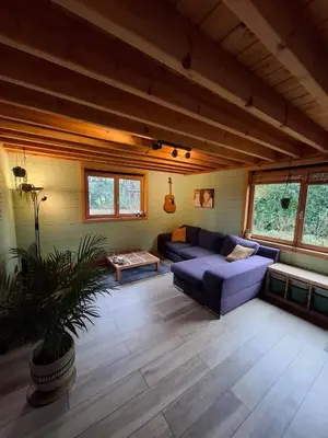 a living room with a couch and a table at Innersoulhouse in Wuustwezel