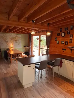 a kitchen with a table and chairs and a dining room at Innersoulhouse in Wuustwezel