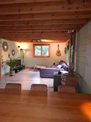 a living room with a couch and a table at Innersoulhouse in Wuustwezel