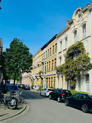 a city street with cars parked in front of buildings at Luxurious stay with zen atmosphere in Zurenborg in Antwerp