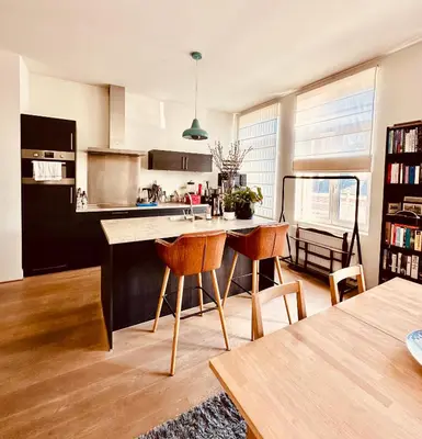 a kitchen with a table and chairs in a room at Luxurious stay with zen atmosphere in Zurenborg in Antwerp