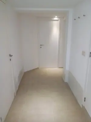 an empty room with white walls and a hallway at relaxation in Waterloo, 2 steps from the center of Brussels in Waterloo