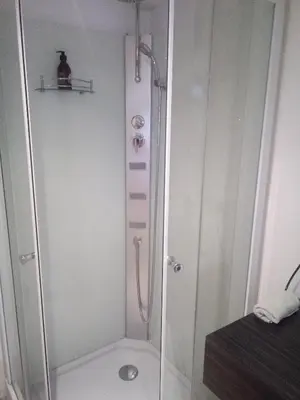 a shower with a glass door in a bathroom at relaxation in Waterloo, 2 steps from the center of Brussels in Waterloo