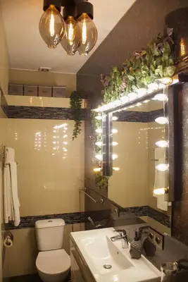 a bathroom with a sink and a toilet and a mirror at The Golden Hour Loft in Brussels