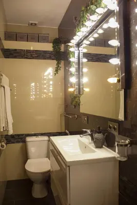 a bathroom with a toilet and a sink and a mirror at The Golden Hour Loft in Brussels